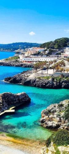 a view of a beach with blue water and rocks at Chiardiluna in Castro di Lecce