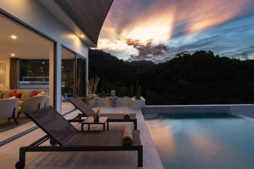 a living room with a pool and a villa at Zog Villas in Koh Samui 