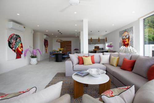 a living room with a couch and a table at Zog Villas in Koh Samui 