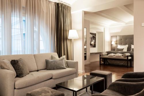 a living room with a couch and a table at Clarion Hotel Post in Gothenburg