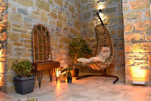 a room with a rocking chair and a mirror at Maslin Otel in Gokceada Town