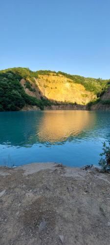 a large body of water with a hill behind it at Fruškogorska kuća - Andrevlje lounge, naselje Testera in Čerević