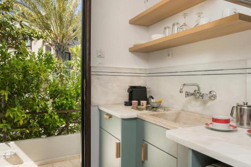 a kitchen with a sink and a window at Hermes Sea View in Stalos