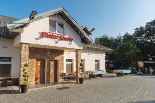 a building with a sign that reads shooting party at Pietro Pokoje B&B Czarna in Czarna
