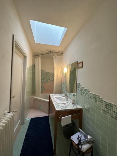a bathroom with a sink and a mirror at Villino Tokupellon Apartments in Cupello