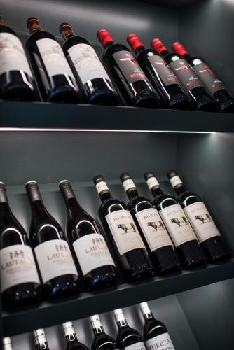 two pictures of bottles of wine in a refrigerator at Dewars Restaurant and Rooms in Malton