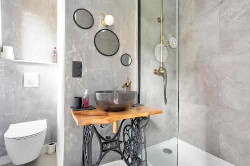 La salle de bains est pourvue d'un lavabo et d'une douche. dans l'établissement Cosy Lodge - Charmant lodge en plein cœur de Dinan, à Dinan