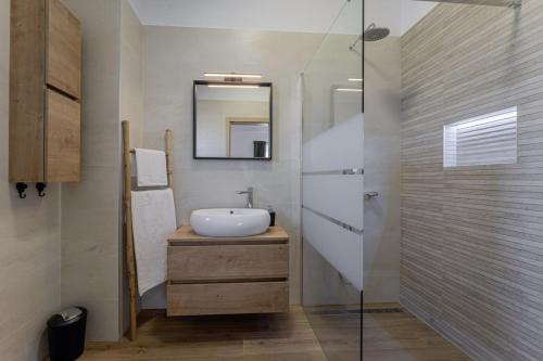 a bathroom with a sink and a mirror at Villa Zani in Loborika - Haus für 6-7 Personen in Loborika