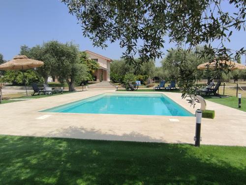 a swimming pool in the yard of a house at Villa Marianna in Alghero