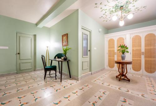 a living room with a table and a chair at ELIVAAS 5 BHK with Pvt Pool, Entertainment Room & Glass House - Bludoor in Marmagao