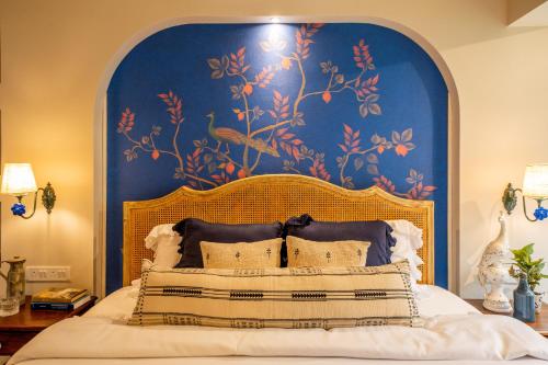 a bedroom with a large bed with a blue wall at ELIVAAS 5 BHK with Pvt Pool, Entertainment Room & Glass House - Bludoor in Marmagao