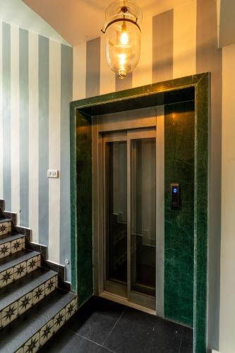 a lobby with a glass door and stairs at ELIVAAS 5 BHK with Pvt Pool, Entertainment Room & Glass House - Bludoor in Marmagao