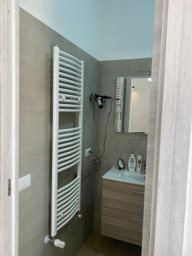 a bathroom with a sink and a mirror at Medusa Apartment in Tropea