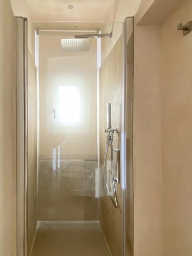 a shower with a glass door in a bathroom at La casa di Irene - Suites con vista in Ragusa