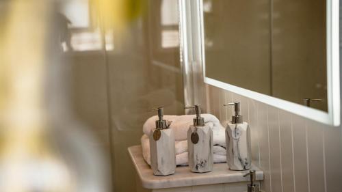 a bathroom with towels and three toothbrushes on a holder at Hornington Manor Luxury Shepherd Huts in York
