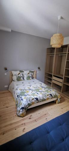 a bedroom with a bed with a floral comforter at Duplex Dax in Dax