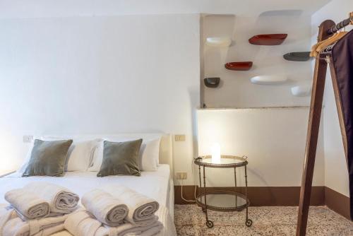 a bedroom with a bed with towels on it at Frantoio Del Moscatello in Camaiore