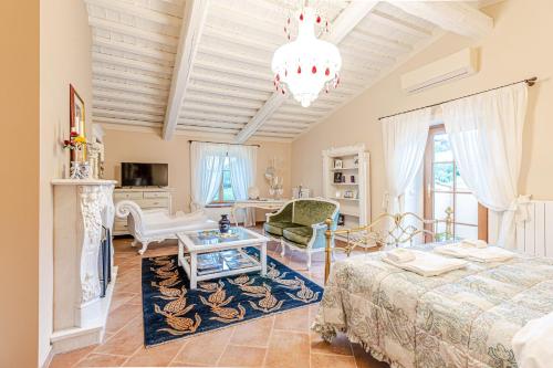 a living room with a bed and a fireplace at Villa Cedri in Montecatini Val di Cecina