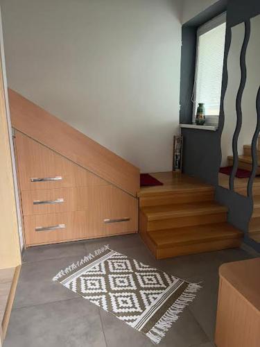 a room with a staircase and a rug on the floor at Dom Melissa v malebnej obci Banka in Piešťany