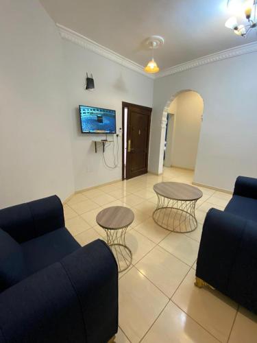 a living room with a couch and two tables at شقق ارين المصيف in Al Hada