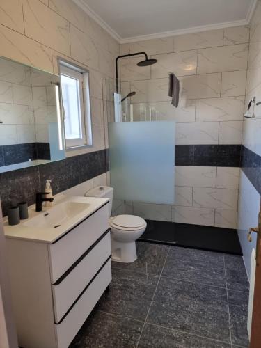 a bathroom with a white sink and a toilet at Golf house Marquesa in Rojales