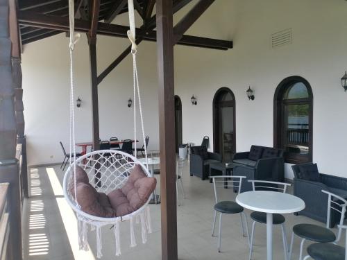 a room with a swing and tables and chairs at Rusaliite Adventure House in Bachevo