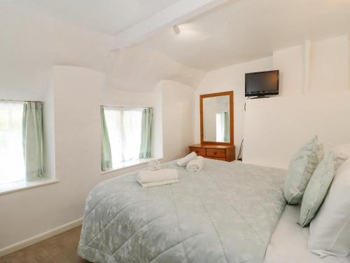 een slaapkamer met een bed met twee handdoeken erop bij Honeybun in Osmington