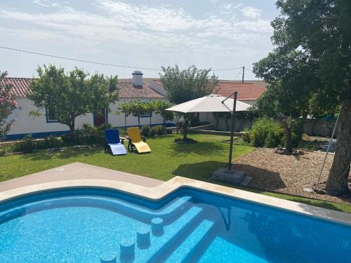 a swimming pool in the yard of a house at Tia Antonia 