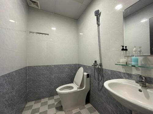 a bathroom with a toilet and a sink at OYO 1190 Valentin Hotel in Da Nang