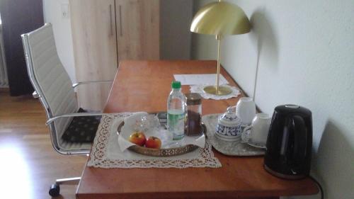 a table with a bottle of water and fruit on it at Schloss Jetzendorf, Verwalterhaus in Jetzendorf
