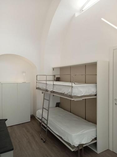 a room with two bunk beds in a room at Neruda Chic House Sant'Angelo in Sant'Angelo D'Ischia