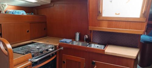a small kitchen with a sink and a stove at One day Sailing Tour San Teodoro Sardinia in Puntaldia
