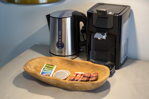 a tray of food sitting next to a coffee maker at De Berkenhof Aparthotel in Nes