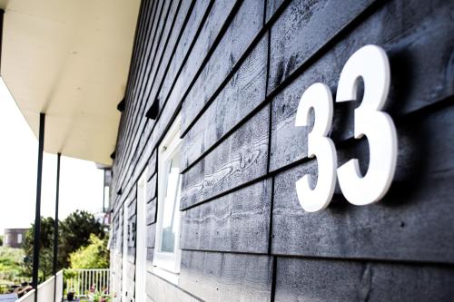 a building with the number on the side of it at De Berkenhof Aparthotel in Nes