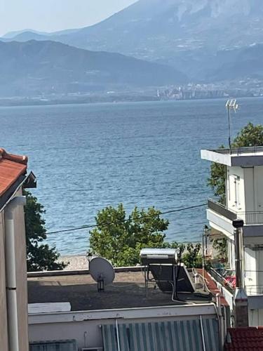 a view of the ocean from the balcony of a house at Διαμέρισμα στη Ναύπακτο in Nafpaktos