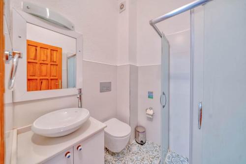 a bathroom with a sink and a toilet and a shower at Villa Pilu in Kaş