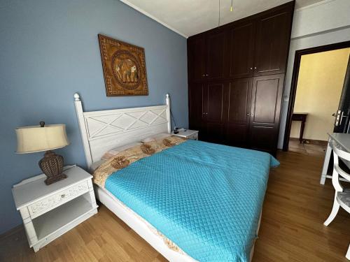 a bedroom with a bed and a table with a lamp at beautiful villa in Kefalos
