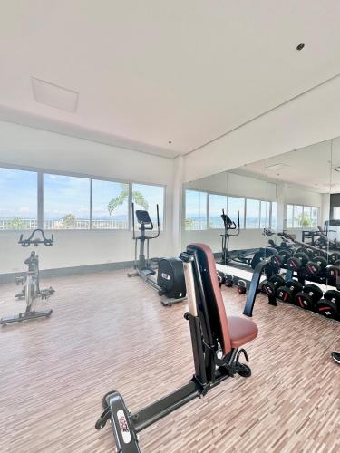 a gym with several treadmills and exercise bikes at Scandinavian 1 BR beside SM CDO w POOL and Netflix in Cagayan de Oro