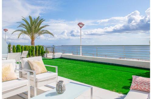 a balcony with green grass and a view of the ocean at MyFlats Infinity View in Arenales del Sol