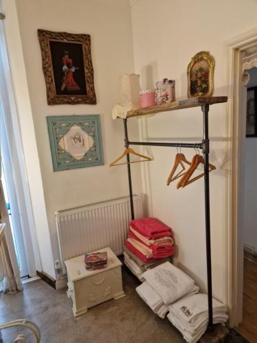 a room with a shelf and some items on a wall at Town Cottage ground floor appartment in Bridgend