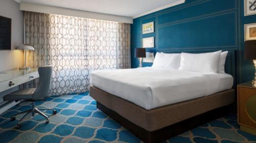 a hotel room with a large bed and a desk at The Ven at Embassy Row, Washington, D.C., a Tribute Portfolio Hotel in Washington