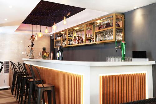 a bar with a bunch of chairs around it at Westine Hotels and Spa in Lagos