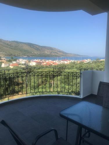 a room with a table and a balcony with a view at Bafas Apartments in Plataria