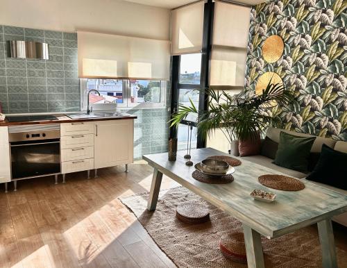 eine Küche und ein Wohnzimmer mit einem Tisch und einem Sofa in der Unterkunft Apartamento paula in San Miguel de Abona