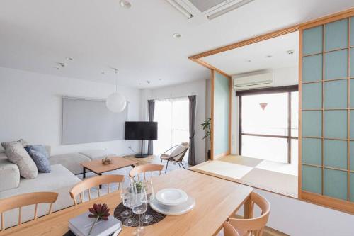a living room with a table and a couch at Pufuka Hikifune ぷふか曳舟 in Tokyo
