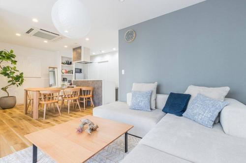 a living room with a white couch and a table at Pufuka Hikifune ぷふか曳舟 in Tokyo