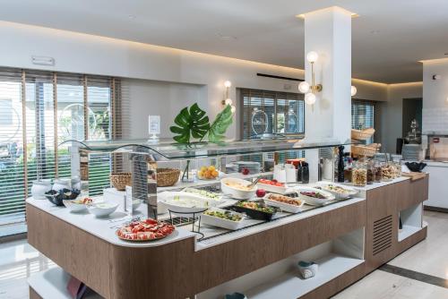 a buffet line with various food items on display at Hotel Matheo Villas & Suites in Malia