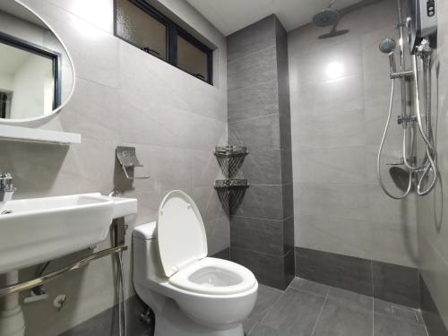 a bathroom with a toilet and a sink and a shower at Duplex Homestay with WiFi & Netflix in Cyberjaya