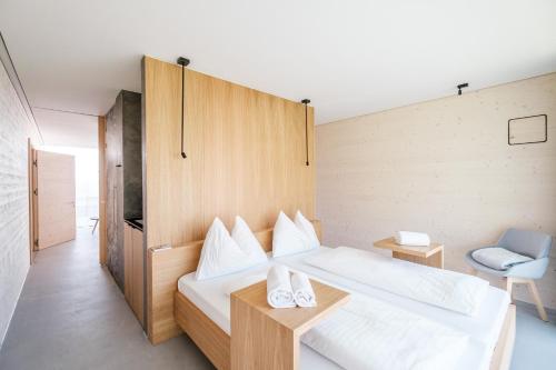 a bedroom with a bed with two shoes on it at Stock & Stein Lodges in Bad Gleichenberg