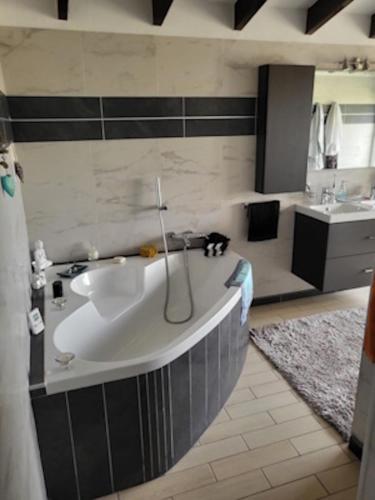 a bathroom with a large tub and a sink at Villa Coma in Denia